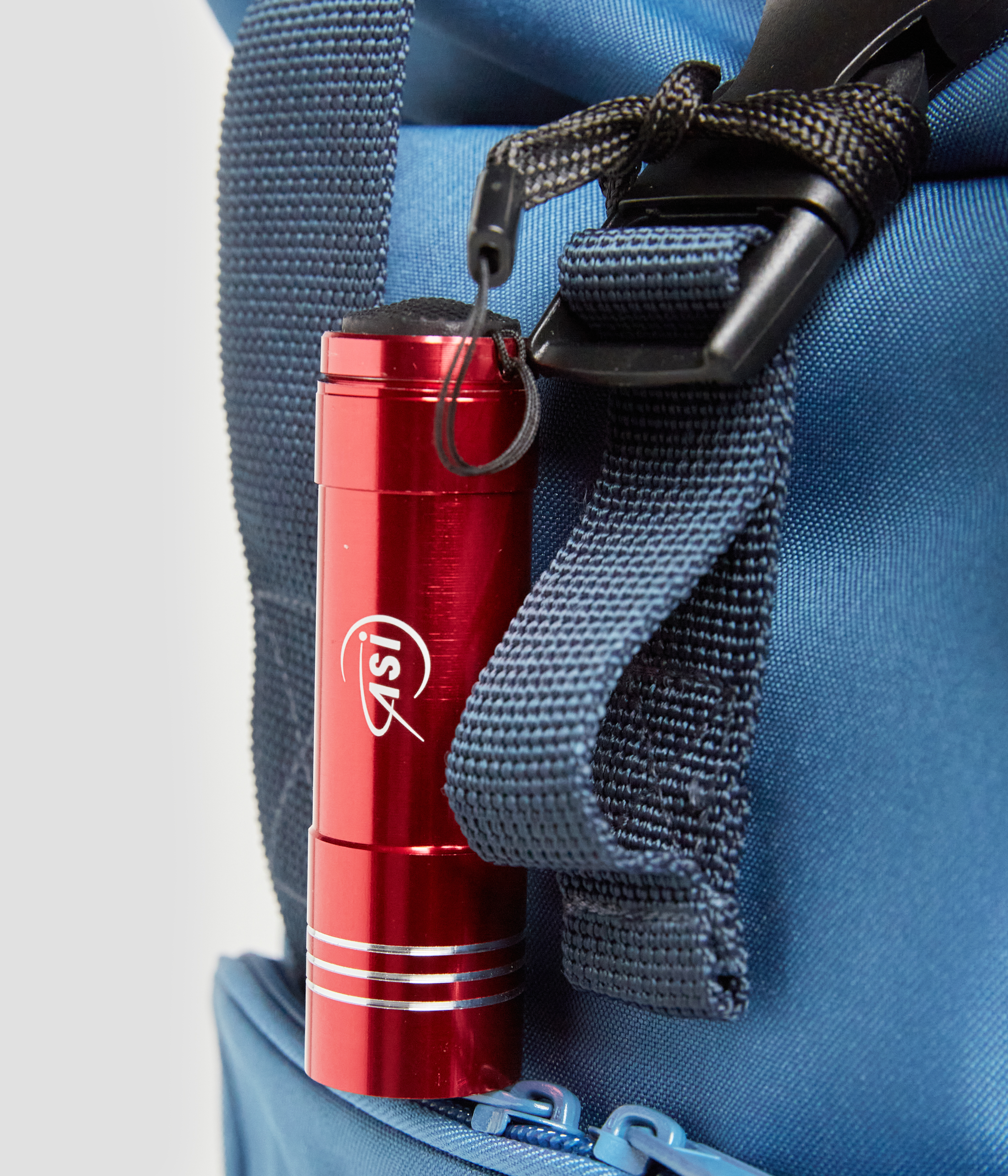 Roll-top backpack with torch and tag set